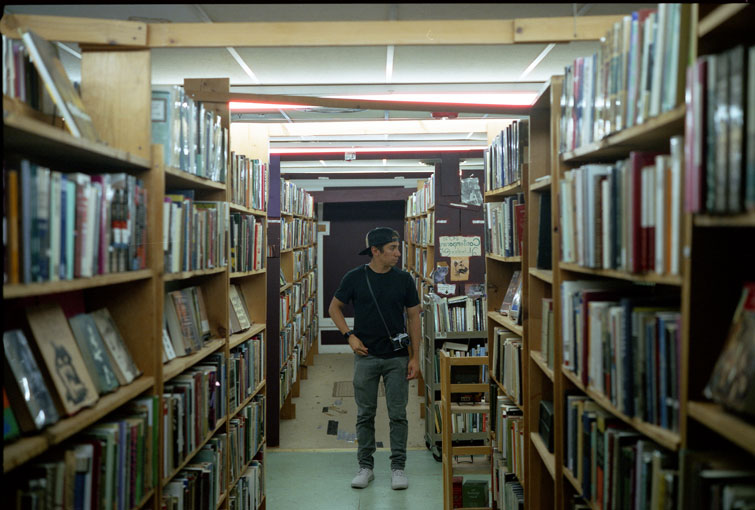 A man walks through an old recycled book store