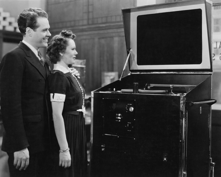 A Couple Viewing a TV A Couple Viewing a TV