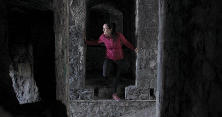 Light levels raised on a scene featuring a woman exploring a castle