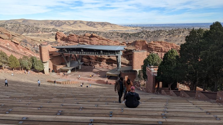 Shot of a canyon in the background and a pavillion with people in the foreground