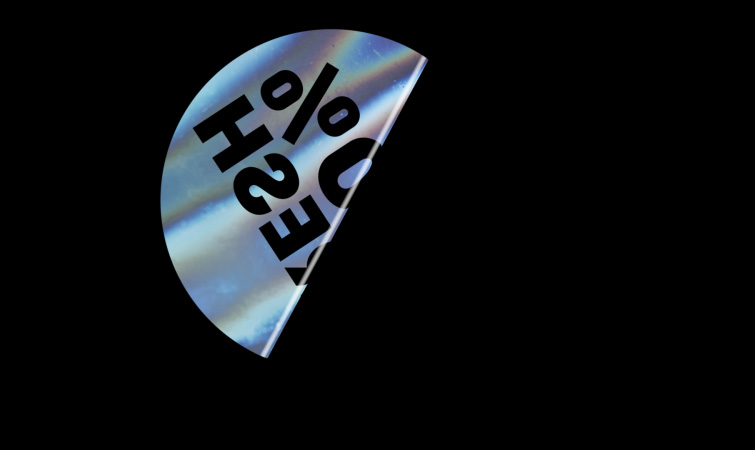 Holographic sticker with text folded in half on black background