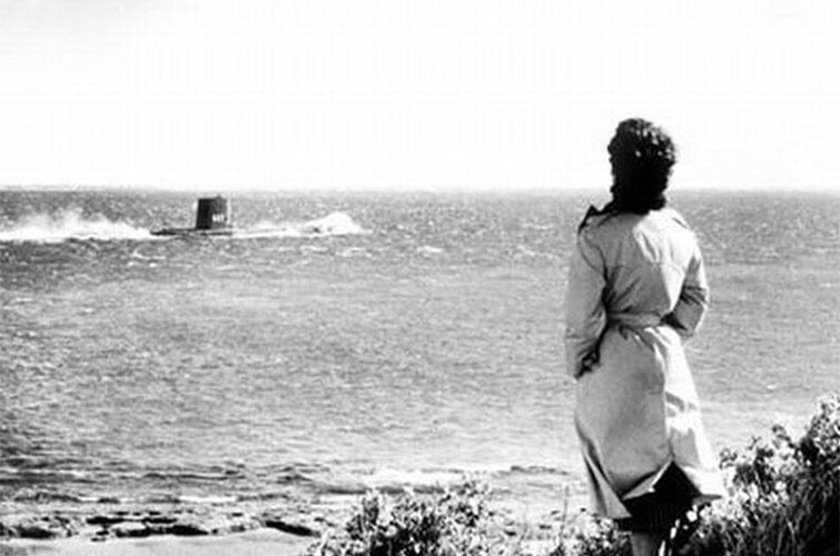 Person stares at a submarine from the beach in the film On the Beach