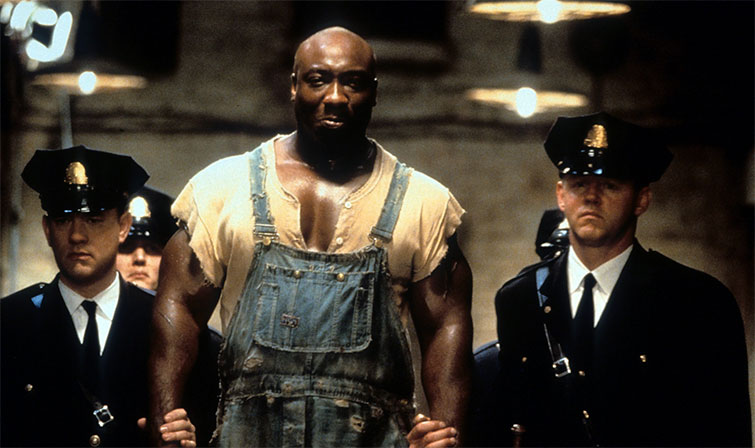 Scene from the movie The Green Mile with guards taking a giant prisoner to his cell