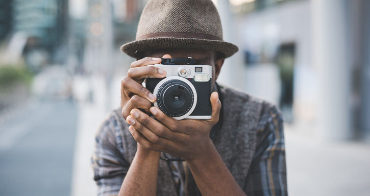 Photographer taking a picture on city street