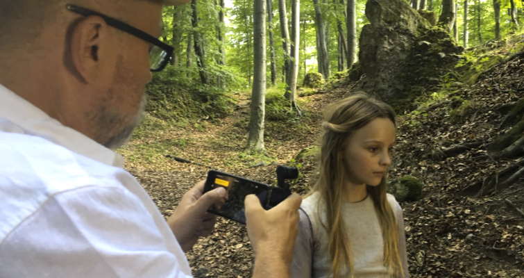 Director filming a scene of a little girl in the woods for the series The Last Kingdom