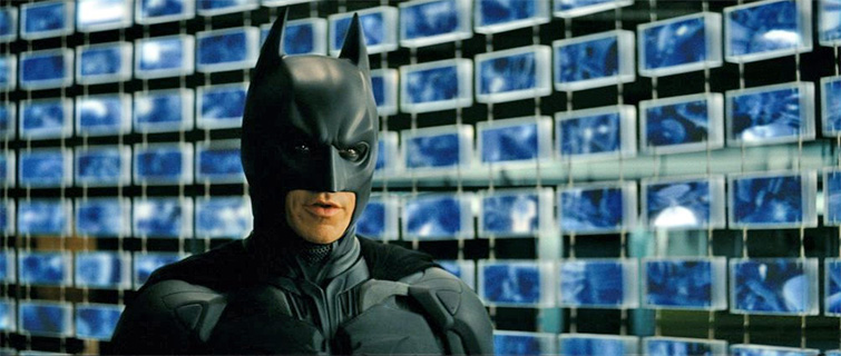 Surveillance in The Dark Knight: Screen grab showing dozens of CTV screens behind The Batman