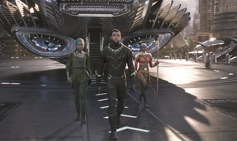 A scene from Marvel's Black Panther. Okoye, T'Challa and Ayo walking out of their aircraft.