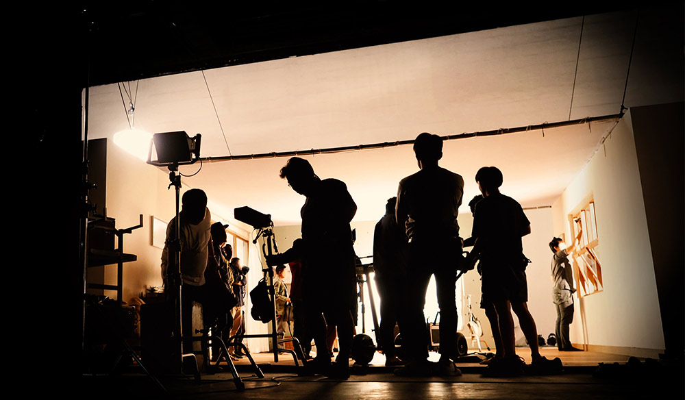 Moody photo of a busy television studio set with production audio