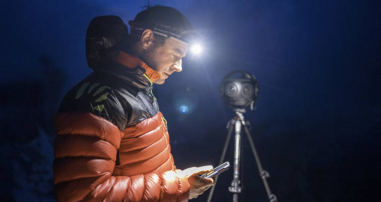 Headlamp-wearing Jonathan Griffith setting up the Insta360 Titan in the dark