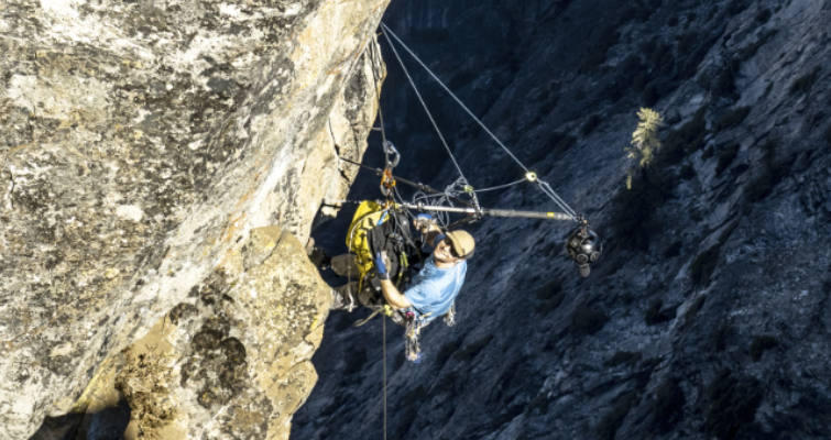 Filmmaker Jonathan Griffith rigging the Insta360 Titan on a cliff face