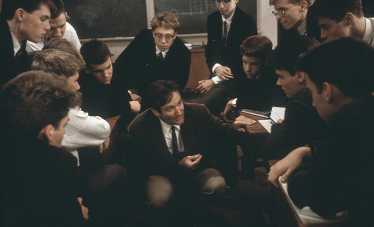 Still of Robin Williams surrounded by his students in Dead Poets Society