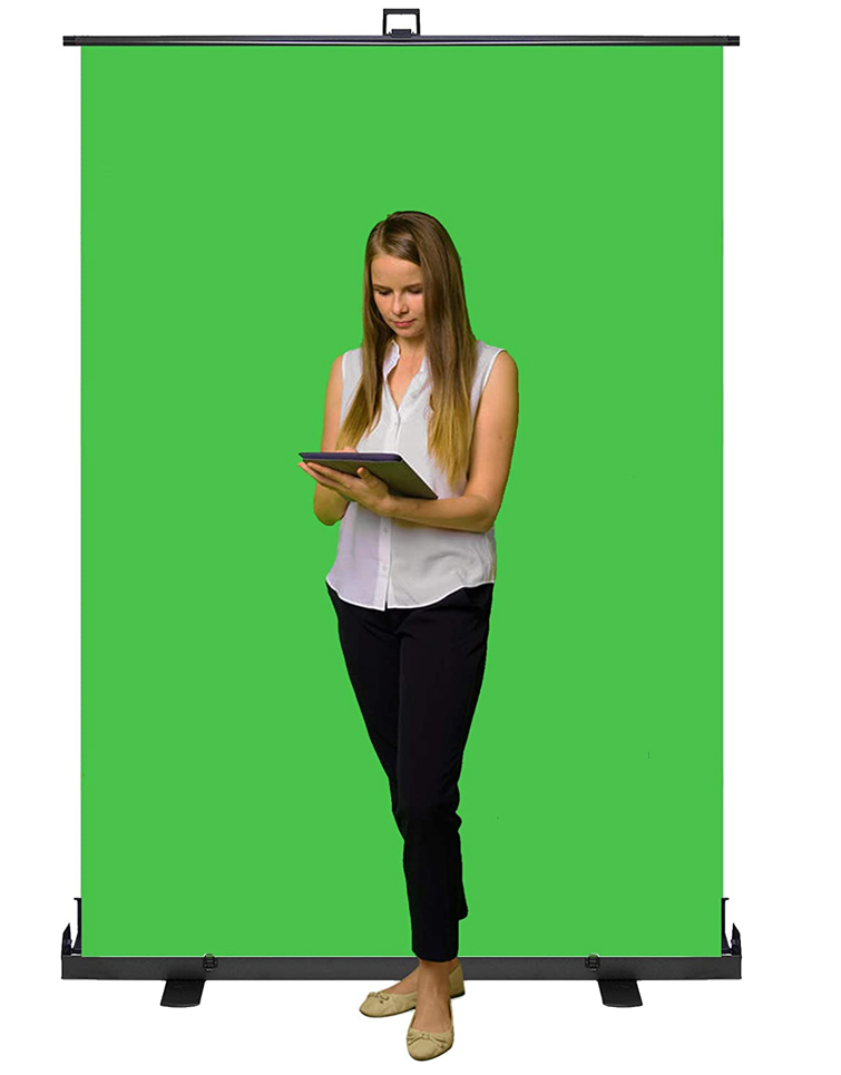 Performer holding an ipad in front of a green screen