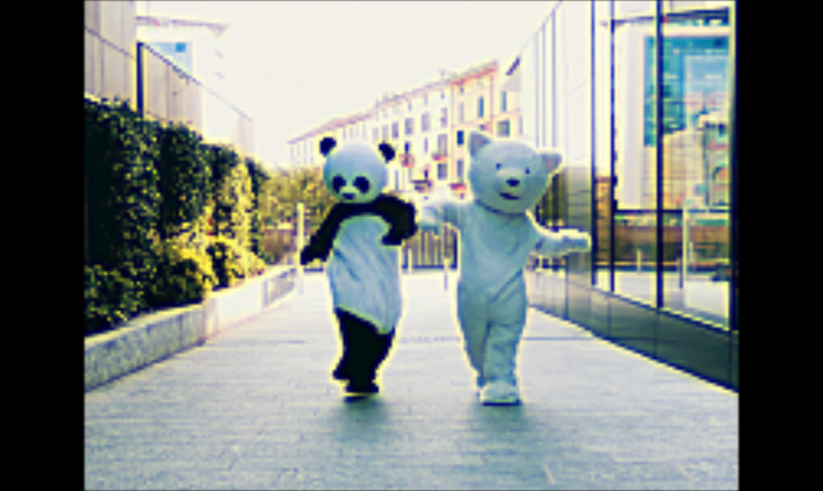 The Unsharp Mask effect added to a photo featuring two people in bear costumes walking down the street
