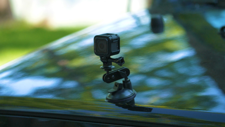 Small action camera mounted to the front of a car