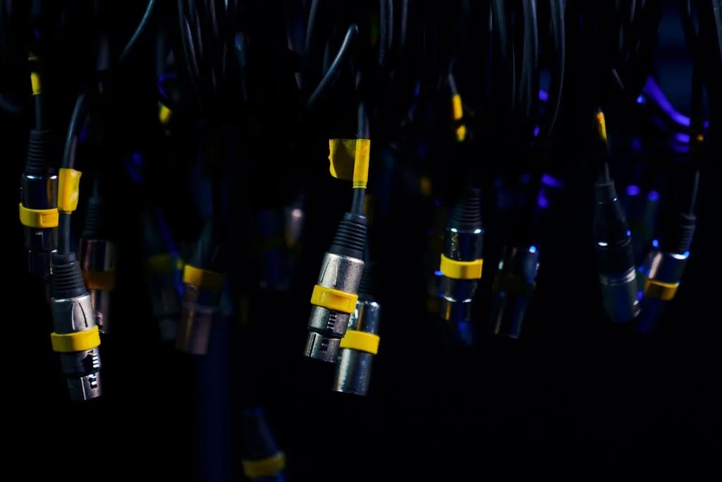 Dangling XLR cables on dark background